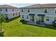 A view of the backyard of a new construction townhome with a patio and green space at 2462 Sweet Viburnum Way, Ocoee, FL 34761