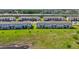 A view of a new construction townhome with a backyard and green space near a pond at 2462 Sweet Viburnum Way, Ocoee, FL 34761