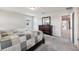 Spacious bedroom with plush carpeting, a decorative dresser, and natural light at 2462 Sweet Viburnum Way, Ocoee, FL 34761