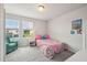 Bright bedroom with two windows, plush carpet, and a comfortable twin size bed at 2462 Sweet Viburnum Way, Ocoee, FL 34761