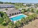 Community pool with covered lounge area and playground, surrounded by palm trees at 2462 Sweet Viburnum Way, Ocoee, FL 34761