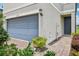 Home exterior with blue garage door, inviting front door, and manicured landscaping at 2462 Sweet Viburnum Way, Ocoee, FL 34761