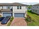 Attractive home with brick driveway, blue garage door, and well-maintained landscaping at 2462 Sweet Viburnum Way, Ocoee, FL 34761