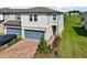 Charming two-story home with brick driveway, landscaping, and blue garage door at 2462 Sweet Viburnum Way, Ocoee, FL 34761