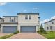 Charming townhouse with a brick driveway, gray siding, and attached garages at 2462 Sweet Viburnum Way, Ocoee, FL 34761