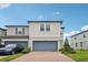 Well maintained and landscaped two story townhome with brick paver driveway and blue garage door at 2462 Sweet Viburnum Way, Ocoee, FL 34761