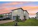 Charming two-story townhome featuring an attached garage, manicured lawn, and a welcoming entrance at 2462 Sweet Viburnum Way, Ocoee, FL 34761