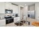 Updated kitchen with stainless appliances, white cabinets, and granite countertops at 2462 Sweet Viburnum Way, Ocoee, FL 34761