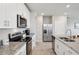 Modern kitchen with stainless steel appliances and granite countertops, offering a sleek design at 2462 Sweet Viburnum Way, Ocoee, FL 34761
