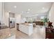 A modern, open-concept kitchen with granite countertops and stainless steel appliances overlooking the living room at 2462 Sweet Viburnum Way, Ocoee, FL 34761