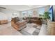 Spacious living room featuring a large sectional couch and ample natural light at 2462 Sweet Viburnum Way, Ocoee, FL 34761