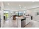 Open-concept living room with kitchen island, stainless appliances, and lots of natural light at 2462 Sweet Viburnum Way, Ocoee, FL 34761