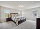 Bright main bedroom featuring neutral walls, carpet, a decorative headboard, and natural light from multiple windows at 2462 Sweet Viburnum Way, Ocoee, FL 34761