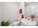 Traditional powder room with pedestal sink and elegant decor at 2462 Sweet Viburnum Way, Ocoee, FL 34761
