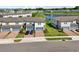 Modern townhomes with brick driveways and attached garages, set around a pond at 2462 Sweet Viburnum Way, Ocoee, FL 34761