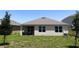 Well-maintained backyard featuring lush grass and the rear exterior of the home at 2569 Trinidad Rd, Haines City, FL 33844