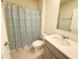 Well-lit bathroom with a shower, toilet, sink, and gray vanity at 2569 Trinidad Rd, Haines City, FL 33844