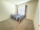Cozy bedroom with carpet, a window with curtains, and a bed at 2569 Trinidad Rd, Haines City, FL 33844