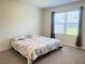 Bedroom with carpet, a queen bed, and a window with gray curtains at 2569 Trinidad Rd, Haines City, FL 33844