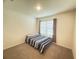 Comfortable bedroom featuring carpet, a window with curtains, and a bed at 2569 Trinidad Rd, Haines City, FL 33844