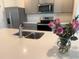 Kitchen with island, stainless steel appliances, and gray cabinets, accented with roses at 2569 Trinidad Rd, Haines City, FL 33844