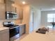 Kitchen featuring gray cabinetry, stainless appliances, and a quartz-topped island at 2569 Trinidad Rd, Haines City, FL 33844