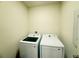 Practical laundry room with modern white washer and dryer units at 2569 Trinidad Rd, Haines City, FL 33844