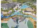 Aerial view of community pool area, lazy river, pirate ship playground, and clubhouse at 2605 Scrapbook St, Kissimmee, FL 34746