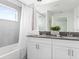 Modern bathroom featuring a double sink vanity and a shower with a tub at 2605 Scrapbook St, Kissimmee, FL 34746