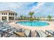Large community pool with ample seating, lush landscaping, and clubhouse in the background at 2605 Scrapbook St, Kissimmee, FL 34746