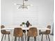 Modern dining room with decorative lighting, textured wall art, and seating for six at 2605 Scrapbook St, Kissimmee, FL 34746