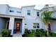 Stylish two-story townhouse featuring modern architectural details and lush landscaping at 2605 Scrapbook St, Kissimmee, FL 34746