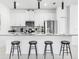 Modern kitchen with bar stool seating at the island and stainless steel appliances at 2605 Scrapbook St, Kissimmee, FL 34746