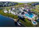 Aerial view of community pool, waterslides, resort style clubhouse, dock and lake access at 2605 Scrapbook St, Kissimmee, FL 34746