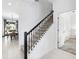 Elegant staircase with dark wood railing and carpeted steps in a bright, modern home at 2605 Scrapbook St, Kissimmee, FL 34746