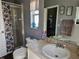 Well lit bathroom with walk-in shower, stylish seashells shower curtain, and neutral tiling at 307 Fox Loop, Davenport, FL 33837