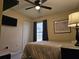Well-lit bedroom features a ceiling fan, closet, neutral walls, and a window letting in natural light at 307 Fox Loop, Davenport, FL 33837