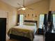 Bedroom features a large bed, vaulted ceilings, lots of natural light, and dark wood furniture at 307 Fox Loop, Davenport, FL 33837