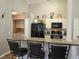 Well-equipped kitchen with a breakfast bar, modern appliances, and a convenient laundry area at 307 Fox Loop, Davenport, FL 33837