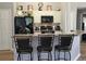 Kitchen featuring a breakfast bar with seating, sleek black appliances, and stylish décor at 307 Fox Loop, Davenport, FL 33837