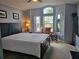 Bright main bedroom showcasing a large window, neutral color scheme, and a comfortable layout at 307 Fox Loop, Davenport, FL 33837