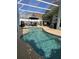 Sparkling pool in screened enclosure, featuring ample space for lounging and dining, creating a perfect outdoor retreat at 307 Fox Loop, Davenport, FL 33837