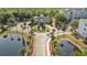 Aerial view of the property with two ponds, a clubhouse, and a water fountain at 3175 Feltrim Pl # 101, Kissimmee, FL 34747
