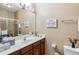 Bathroom featuring a wide mirror, modern sink, and stylish decor elements at 3175 Feltrim Pl # 101, Kissimmee, FL 34747