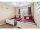 Comfortable bedroom featuring two twin beds, soft linens, and a bright window view at 3175 Feltrim Pl # 101, Kissimmee, FL 34747