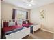 Bright bedroom features two twin beds, ceiling fan, and sunny window at 3175 Feltrim Pl # 101, Kissimmee, FL 34747