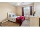 Cozy bedroom with a ceiling fan, natural light from the window, and a comfortable bed at 3175 Feltrim Pl # 101, Kissimmee, FL 34747