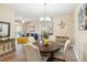 Dining room with table and chairs flowing to living room, neutral carpet, and modern light fixture at 3175 Feltrim Pl # 101, Kissimmee, FL 34747
