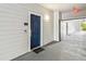 Condo entrance featuring a dark blue door, sidelight, door bell, security system, and unit number at 3175 Feltrim Pl # 101, Kissimmee, FL 34747