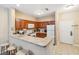 Bright kitchen features wood cabinetry, white appliances, and a breakfast bar with seating at 3175 Feltrim Pl # 101, Kissimmee, FL 34747